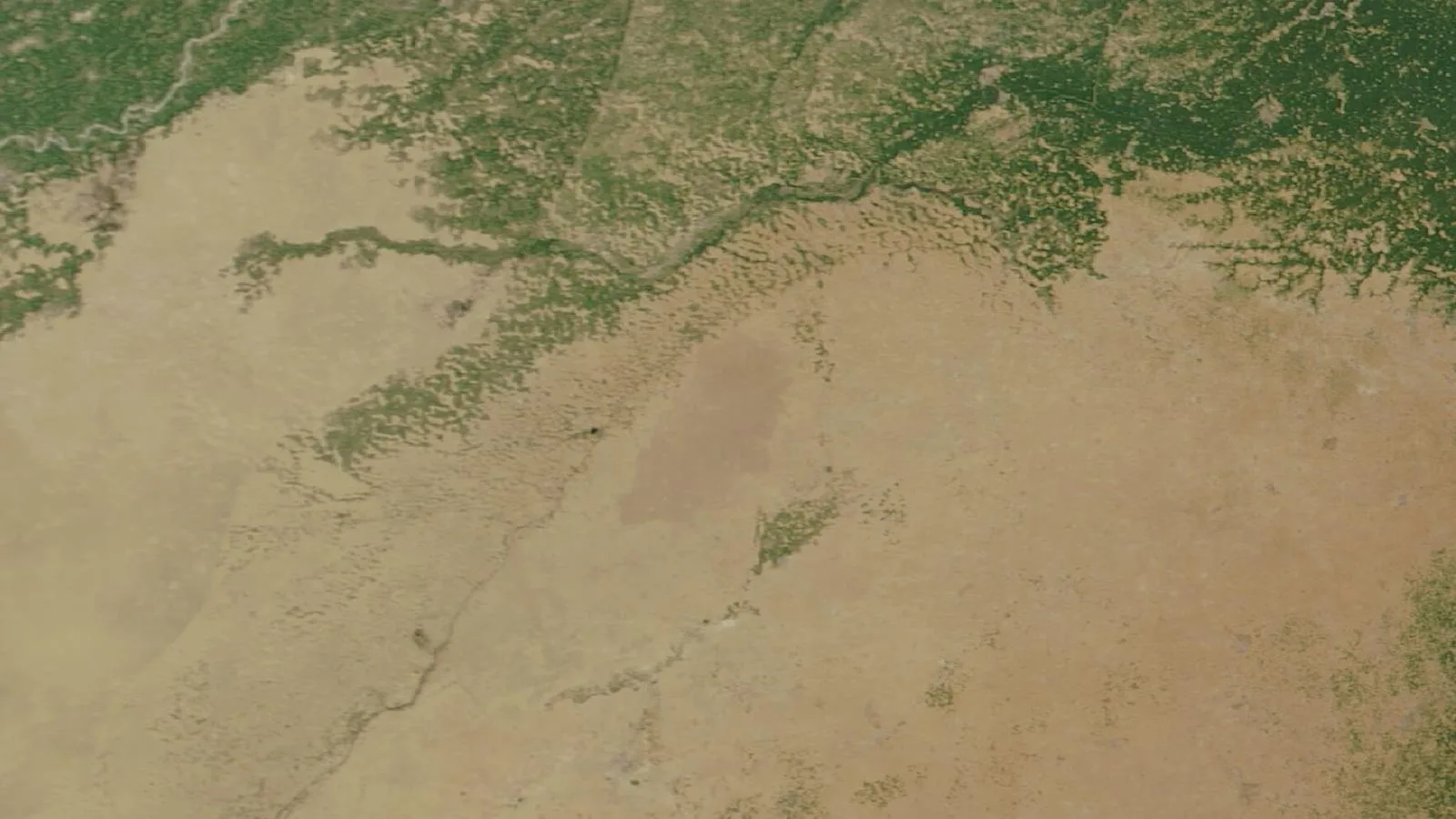 Satellite image, March 2002: mostly bare sand, with farmland only along the northern canal belt.
